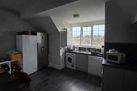 Bright kitchen with large window and appliances...