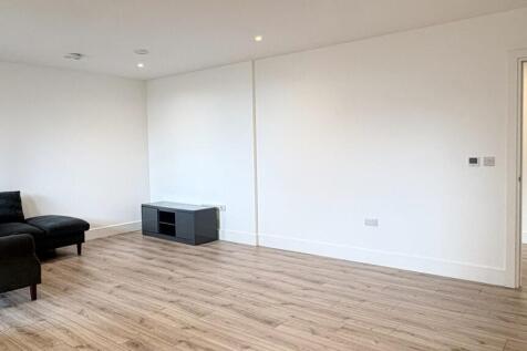 Bright, modern living room with light wood floo...