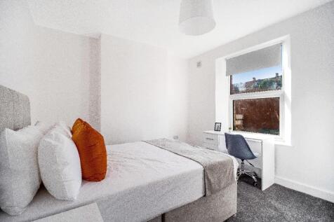 Bright, neatly presented bedroom with a comfort...