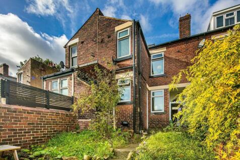 Charming rear garden with established shrubs, a...