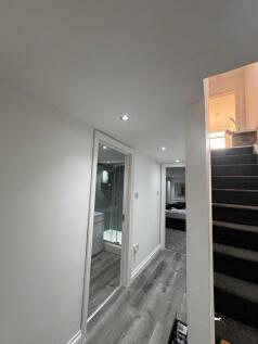 A clean and modern hallway featuring wood-effec...