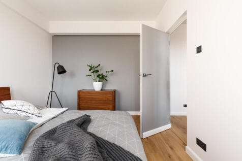 grey-blanket-on-bed-in-minimal-bedroom-interior-wi