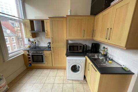 Bright kitchen with modern integrated appliance...