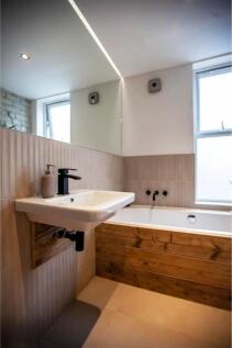 Contemporary bathroom with wood-accent bath pan...