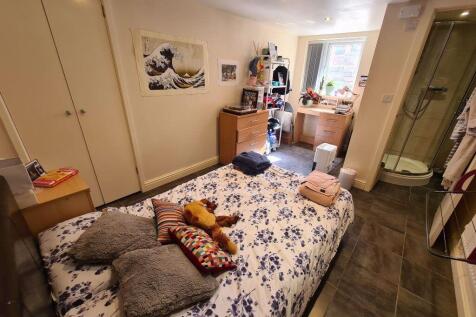 A cozy master bedroom featuring a comfortable d...