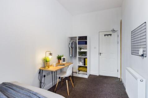 A bright and tidy double bedroom featuring a wo...