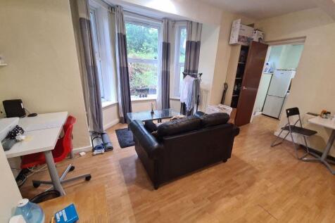 Bright and welcoming living room with ample nat...
