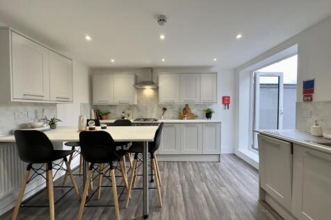 A modern and spacious kitchen with ample natura...