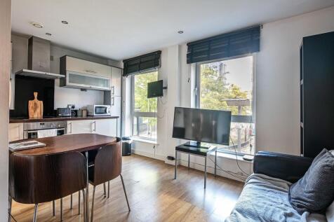 Bright open-plan living area with modern kitche...