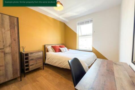 Bright modern bedroom with stylish feature wall...
