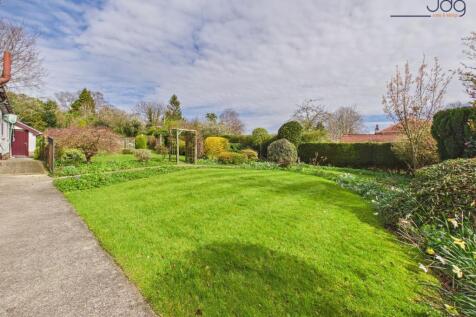 Wraparound mature gardens with expansive lawns
