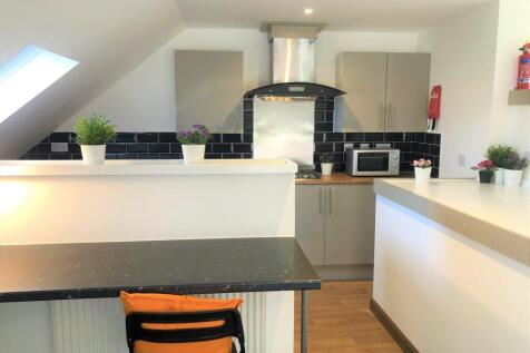 Bright and modern kitchen featuring sleek black...
