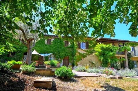 Beautiful house surrounded by lush greenery and ma