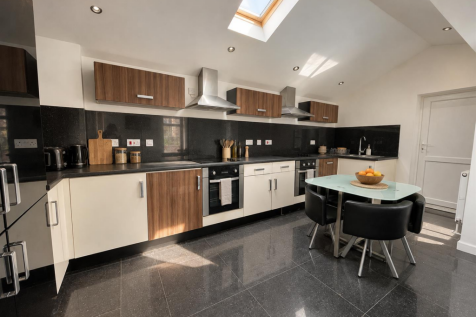 Sunlit Walnut and Black Kitchen.png