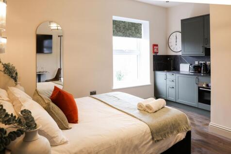 Elegant studio room with modern kitchenette...