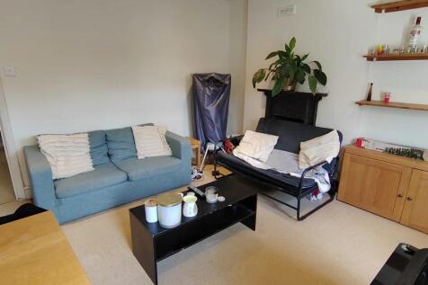 Cosy lounge with comfy sofas and wooden storage...