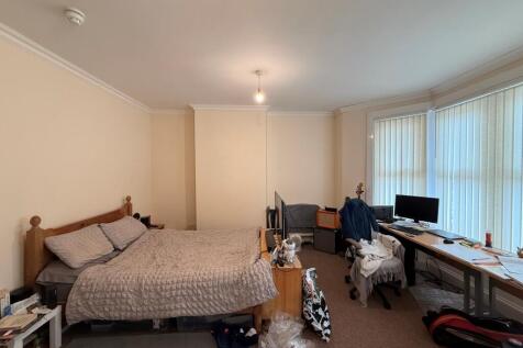Spacious, airy bedroom with a large double bed,...