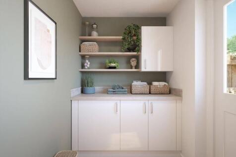 A handy utility room sits to the rear of the home