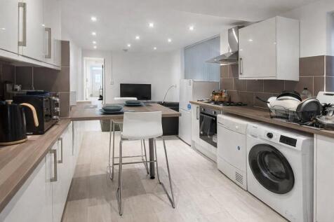 Modern galley kitchen with wood-effect worktops...