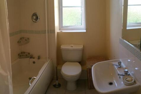 Bright bathroom with a classic white suite incl...