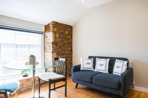 Living room with exposed stone wall