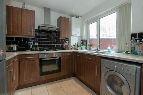 A modern kitchen featuring stylish wooden cabin...