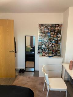 Bright, neatly arranged bedroom with modern whi...