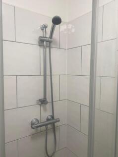 Modern tiled shower enclosure with an adjustabl...