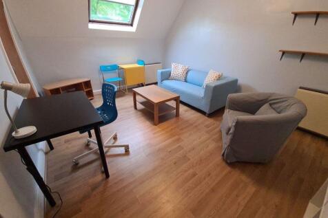 Bright and cozy living room featuring a skyligh...