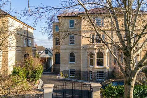 Elegant stone-fronted period building with gate...