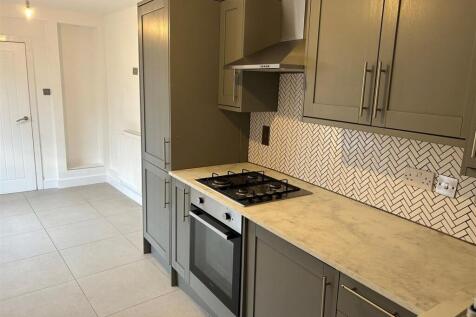 Modern kitchen with stylish cabinets and tiling...