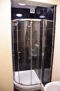 Modern bathroom featuring a sleek enclosed show...