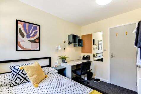 Bright bedroom with modern desk and stylish dec...