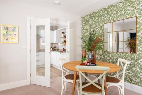 a dining room with a table and chairs