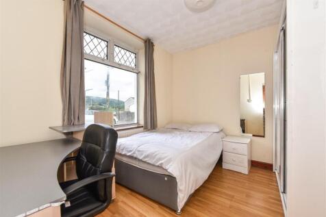 Bright bedroom with large desk and double bed...