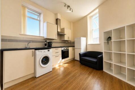 Bright kitchen with modern units and seating...