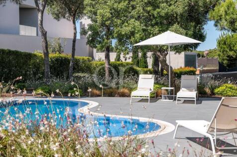 Pool terrace with sunloungers and parasol