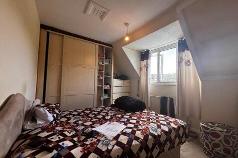 Bright bedroom with integrated storage solution...