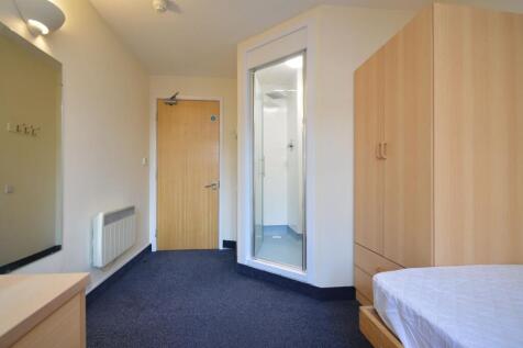 Compact room with ensuite shower and built-in w...
