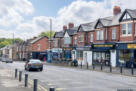 Vibrant local street with shops and cafes nearb...