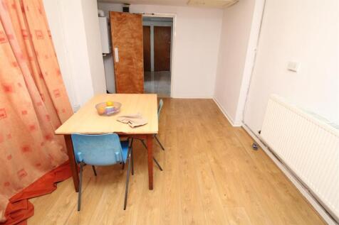 Bright dining space with warm wood flooring...