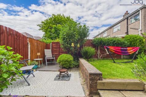 Tiered Garden with a mixture of flags, decking and lawn.
