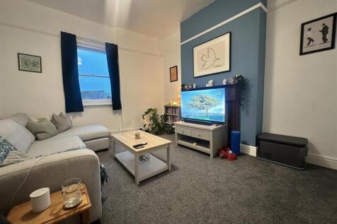 Stylish lounge with feature wall and large sofa...