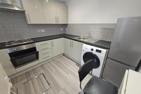 A modern, well-maintained kitchen featuring whi...