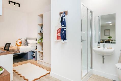 Bright, modern en-suite bedroom with a comforta...
