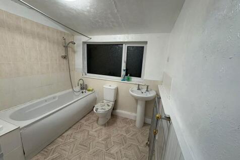 Bright bathroom with bath and window...