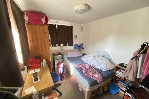 Bright single room with desk and storage...
