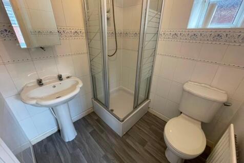 Bright, well-maintained bathroom with a corner ...