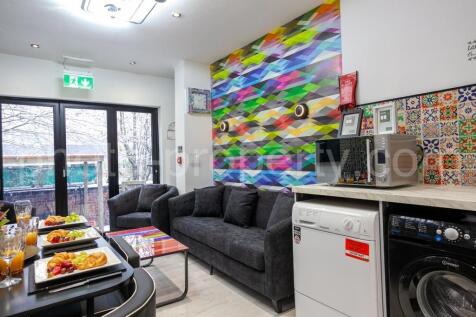 Bright, modern communal lounge with comfortable...