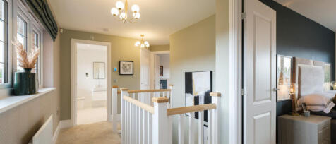 Interior view of a modern home with a staircase, bedroom, and bathroom, featuring neutral colours an